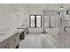 Modern bathroom with dual vanities, a luxurious freestanding tub, and glass-enclosed shower at 7615 Se 12Th Cir, Ocala, FL 34480