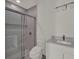 Clean bathroom featuring a shower with glass doors, mosaic tile accent, and a modern vanity with sink at 7615 Se 12Th Cir, Ocala, FL 34480