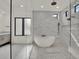 Modern bathroom featuring a freestanding tub, walk-in shower, and stylish fixtures at 7615 Se 12Th Cir, Ocala, FL 34480