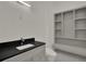 Bathroom with a vanity with a black countertop and built in shelves at 7615 Se 12Th Cir, Ocala, FL 34480