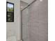 Bathroom featuring a glass-enclosed shower with gray tiles and a modern toilet at 7615 Se 12Th Cir, Ocala, FL 34480