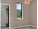 Bedroom featuring a tall window to the outdoors, a modern light fixture, and access to walk-in closet at 7615 Se 12Th Cir, Ocala, FL 34480