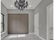 Bedroom with a chandelier, closet with sliding doors, and marble-look floors at 7615 Se 12Th Cir, Ocala, FL 34480