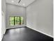 Bright, minimalist bedroom has high ceilings and a large window to the outside at 7615 Se 12Th Cir, Ocala, FL 34480