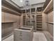 Spacious walk-in closet with custom shelving, island, chandelier and glass display cases at 7615 Se 12Th Cir, Ocala, FL 34480