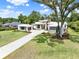 Modern home featuring stone accents and a sprawling lawn creating a serene and inviting outdoor space at 7615 Se 12Th Cir, Ocala, FL 34480