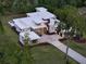 Modern home boasts a sleek, flat roof design and a spacious driveway, set amid lush landscaping at 7615 Se 12Th Cir, Ocala, FL 34480