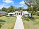 Modern home boasts stone accents and a sprawling lawn, creating a serene and inviting outdoor space at 7615 Se 12Th Cir, Ocala, FL 34480