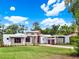 Contemporary home with a stone facade, neat landscaping, and modern garage doors at 7615 Se 12Th Cir, Ocala, FL 34480