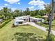 Modern home showcasing clean architecture, stone detailing, and a spacious yard on a sunny day at 7615 Se 12Th Cir, Ocala, FL 34480