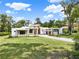 Contemporary home exhibits clean architecture, stone detailing, and lush greenery, exuding modern elegance at 7615 Se 12Th Cir, Ocala, FL 34480