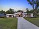 Contemporary home showcasing modern architecture, a well-kept lawn, and elegant curb appeal at 7615 Se 12Th Cir, Ocala, FL 34480