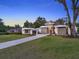 Modern home with a well-manicured lawn, contemporary design, and a welcoming driveway at 7615 Se 12Th Cir, Ocala, FL 34480