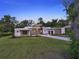 Elegant modern home featuring clean lines, manicured landscaping, and a long, inviting driveway at 7615 Se 12Th Cir, Ocala, FL 34480