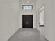 Bright foyer with a contemporary light fixture and light grey marble flooring throughout at 7615 Se 12Th Cir, Ocala, FL 34480