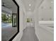 Hallway view of the pool featuring large windows and modern white cabinetry at 7615 Se 12Th Cir, Ocala, FL 34480