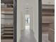 Hallway view from closet; highlights architectural details, chandelier, and tiled floor at 7615 Se 12Th Cir, Ocala, FL 34480