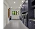 Laundry room with new dark blue cabinetry and large washer and dryer units at 7615 Se 12Th Cir, Ocala, FL 34480
