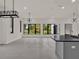 Bright living room features large windows, modern lighting, and gray tile flooring at 7615 Se 12Th Cir, Ocala, FL 34480