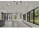 Bright open-concept living area featuring wet bar and floor to ceiling windows at 7615 Se 12Th Cir, Ocala, FL 34480