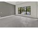 Bright living room with backyard views overlooking in-ground pool and landscaping at 7615 Se 12Th Cir, Ocala, FL 34480