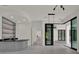 Contemporary living space with wet bar and large sliding glass doors leading to the patio at 7615 Se 12Th Cir, Ocala, FL 34480