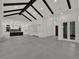 Open-concept living room features high beamed ceilings and view of gourmet kitchen at 7615 Se 12Th Cir, Ocala, FL 34480