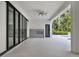 Covered patio with a fireplace, tile flooring, and expansive sliding glass doors leading to a pool at 7615 Se 12Th Cir, Ocala, FL 34480