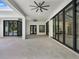 Spacious open patio with black framed sliding glass doors to the home's interior at 7615 Se 12Th Cir, Ocala, FL 34480