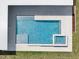 Aerial top-down view of pool featuring spa, sun deck, and stairs into pool at 7615 Se 12Th Cir, Ocala, FL 34480