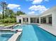 Backyard pool with spa, stainless grill area, and covered patio area at 7615 Se 12Th Cir, Ocala, FL 34480