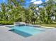 View of pool with waterfall features and lush landscaping in the backyard at 7615 Se 12Th Cir, Ocala, FL 34480