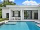 Backyard pool with spa and stainless grill area under the covered patio at 7615 Se 12Th Cir, Ocala, FL 34480