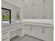 Room with modern white cabinets, stainless steel hardware and quartz countertops at 7615 Se 12Th Cir, Ocala, FL 34480