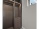 Spacious walk-in closet with custom shelving, drawers, and ample storage space, enhanced by overhead lighting at 7615 Se 12Th Cir, Ocala, FL 34480