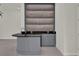 Elegant wet bar boasts modern finishes, built-in shelving, and black countertop at 7615 Se 12Th Cir, Ocala, FL 34480