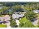 Aerial view of a suburban home with a view of a lake in the distance at 7618 Majestic Pine Ct, Orlando, FL 32819
