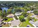 Aerial view showcases a neighborhood with tree-lined streets, ponds, and well-kept homes at 7618 Majestic Pine Ct, Orlando, FL 32819