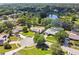 A beautiful aerial view of a quiet neighborhood surrounding a pond with mature trees and green lawns at 7618 Majestic Pine Ct, Orlando, FL 32819