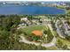 Overhead view of community park featuring a baseball field, playground, parking, and walking paths by a lake at 7618 Majestic Pine Ct, Orlando, FL 32819