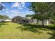 The backyard offers an oversized screened-in pool, lush landscaping and mature trees for ultimate privacy at 7618 Majestic Pine Ct, Orlando, FL 32819