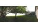 A mature tree in this backyard provides shade and beauty near the screen-enclosed pool at 7618 Majestic Pine Ct, Orlando, FL 32819