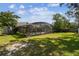 Spacious backyard with screened-in pool and patio features mature trees that provide shade and privacy at 7618 Majestic Pine Ct, Orlando, FL 32819