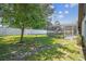Large backyard with mature trees and a view of the screened-in pool, creating a peaceful and private outdoor space at 7618 Majestic Pine Ct, Orlando, FL 32819