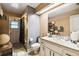 Neutral bathroom with a white vanity, toilet, and shower/tub combo with a shower curtain at 7618 Majestic Pine Ct, Orlando, FL 32819