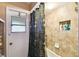 Bathroom featuring a tiled shower with a shower curtain and a built-in shelving niche for toiletries at 7618 Majestic Pine Ct, Orlando, FL 32819