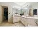 The bathroom features a large mirror, a double sink vanity and carpet floors at 7618 Majestic Pine Ct, Orlando, FL 32819