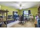 Green bedroom featuring a ceiling fan, window, and furnishings including a gaming chair at 7618 Majestic Pine Ct, Orlando, FL 32819