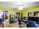Bright bedroom with green walls, ceiling fan, closet, and door leading to other rooms at 7618 Majestic Pine Ct, Orlando, FL 32819