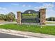 This sign for Shadow Bay Park features stone columns and a lush landscape around the base at 7618 Majestic Pine Ct, Orlando, FL 32819